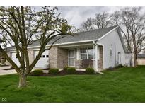 Charming single-story home with well-manicured lawn and inviting front porch at 1008 E Apple Lake Dr, Greenfield, IN 46140