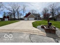 Beautiful home with a long driveway and a spacious two-car garage on a well maintained lawn at 1066 N Dogwood Way, Greenfield, IN 46140