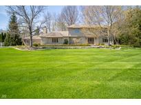Attractive home featuring manicured landscaping, stone accents, and a lush, green lawn at 130 Governors Ln, Zionsville, IN 46077