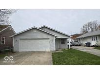 Charming single-story home featuring a gray exterior, attached garage, and well-maintained front yard at 1414 Waldemere Ave, Indianapolis, IN 46241