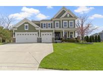 Charming two-story home with a well-manicured lawn, attached three car garage and lovely landscaping at 15385 Ellington Dr, Fishers, IN 46040