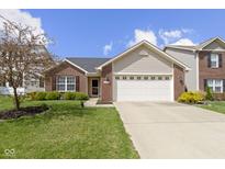 Charming single-Gathering home with brick and siding, a two-car garage, and a well-manicured front yard at 15501 Landsbrook E Run, Noblesville, IN 46060