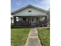 Charming home with brick accents and a covered porch, surrounded by a well-maintained lawn at 1625 E Thompson Rd, Indianapolis, IN 46227