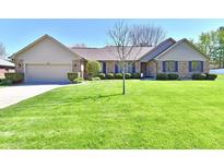 Charming brick home with manicured lawn, neat shrubbery and a welcoming two car garage at 1927 Pheasant Way, Greenwood, IN 46143
