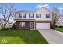 Charming two-story home featuring brick accents, manicured lawn, and attached two car garage at 19510 Pathway Point, Noblesville, IN 46062