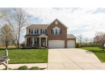 Beautiful two-story brick home featuring a manicured lawn and a long driveway leading to a spacious three-car garage at 2093 Autumn Faith Way, Avon, IN 46123