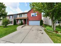 Two-story home with brick and vinyl siding, well-kept lawn, and two-car garage at 3316 Gainesville Ct, Indianapolis, IN 46227