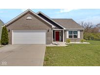 Charming brick home featuring an attached two-car garage and a bright red front door at 4323 Stubbington Ln, Indianapolis, IN 46239