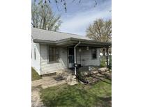 Charming single-story home featuring a covered front porch, neat yard, and mature trees at 434 N 18Th Ave, Beech Grove, IN 46107