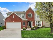 Charming two-story home with a brick facade, attached garage, and manicured lawn at 4546 Creighton Ln, Indianapolis, IN 46237