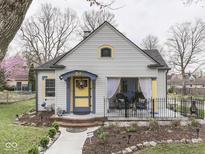 Charming home featuring a covered porch, colorful accents, and well-maintained landscaping at 57 Worman St, Indianapolis, IN 46227
