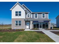 Two-story home with gray siding, brick accents, manicured lawn, and a welcoming entrance at 7636 Big Bend Blvd, Camby, IN 46113