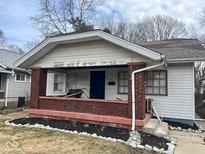 Modest home with a front porch needing some TLC at 801 N Denny St, Indianapolis, IN 46201