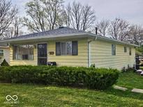 Charming single-story home with a well-maintained lawn and mature hedges at 8412 E 47Th St, Indianapolis, IN 46226
