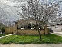 Charming brick bungalow-style home with a well-maintained front lawn at 1020 N Colorado Ave, Indianapolis, IN 46201
