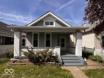 Charming bungalow with inviting front porch, showcasing its classic architectural details at 1140 Hoyt Ave, Indianapolis, IN 46203