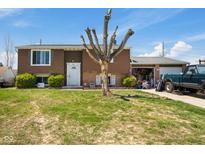 Split-level home featuring brown siding, an attached garage and a lawn at 1206 Rosengarten Dr, Greenwood, IN 46142