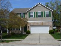 Charming two-story home with attached two car garage, manicured lawn and mature tree at 12326 River Valley Dr, Fishers, IN 46037