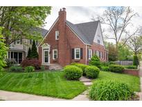 Charming brick home with manicured lawn and lush landscaping offers timeless curb appeal at 171 W 44Th St, Indianapolis, IN 46208