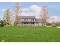 Charming two-story home with a well-manicured lawn, covered porch, and vibrant landscaping at 180 S 400 W, Lebanon, IN 46052