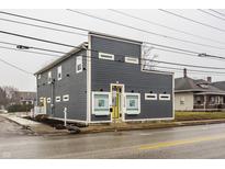 Modern two-story building with gray siding and a unique architectural design on an overcast day at 2329 Shelby St, Indianapolis, IN 46203