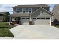 Charming two-story home with a two-car garage, manicured lawn, and neutral colored siding at 4390 Risen Star Way, Bargersville, IN 46106
