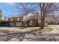 Charming brick home featuring balconies, a two-car garage, and mature trees in a residential neighborhood at 456 E Arch St, Indianapolis, IN 46202