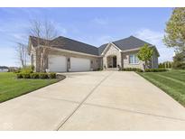 Stunning single-Gathering home with a stone and brick facade, three-car garage, and beautifully landscaped front yard at 5348 Ashby Ct, Greenwood, IN 46143