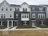Charming townhome exterior with stone accents, offering a welcoming curb appeal at 5964 Lomita Ave, Plainfield, IN 46168