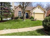Charming brick home boasts a well-manicured lawn and a lovely garden, enhancing its curb appeal at 701 Danver Ln, Beech Grove, IN 46107