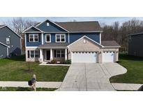 Charming two-story home with a brick and blue facade and a well-manicured lawn at 9207 Foudray N Cir, Avon, IN 46123