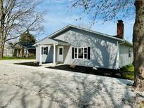 Charming one-story home with gray siding, black shutters, and a well-manicured front yard at 103 N Nebraska St, North Salem, IN 46165