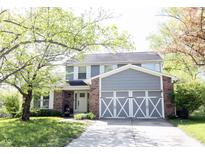 Charming two-story home featuring a brick facade, gray siding, and a beautifully landscaped front yard at 1123 Barley Cir, Carmel, IN 46032
