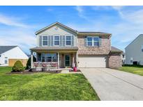 Charming two-story home with brick and siding, attached two-car garage, and covered front porch at 1330 Redwood Dr, Greenfield, IN 46140