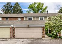 Townhome featuring a single-car garage, brick accents, and a manicured lawn, offering convenient parking and curb appeal at 156 Aspen Way, Carmel, IN 46032