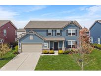 Beautiful two-story home with blue siding, a well-manicured lawn, and an attached two-car garage at 15723 Myland Dr, Noblesville, IN 46062