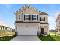Beautiful two-story home with a two-car garage, manicured lawn, and classic architectural details at 2252 Marjorie Way, Shelbyville, IN 46176