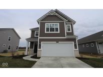 Beautiful two-story home with a two-car garage, brown siding, and a well-manicured lawn at 2268 Marjorie Way, Shelbyville, IN 46176