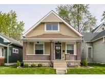 Charming bungalow-style home with a welcoming front porch, brick accents, and well-maintained lawn at 420 Orange St, Indianapolis, IN 46225