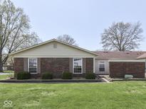 Charming brick home featuring manicured front lawn and mature trees at 4412 Mountbatten Ct, Indianapolis, IN 46254