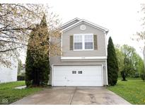 Charming home featuring a two-car garage and a well-maintained front yard with mature landscaping at 4545 Connaught East Dr, Plainfield, IN 46168