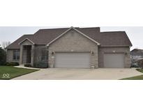 Charming brick home with a well-maintained lawn and a spacious two-car garage at 6087 Boulder Ct, Columbus, IN 47201