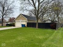 A two-car garage sits next to a well-maintained lawn, providing ample parking and curb appeal to the home at 676 Sunblest Blvd, Fishers, IN 46038