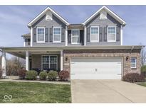 Inviting two-story home with blue siding, brick accents, and a well-manicured front yard at 8926 New Heritage Ct, Indianapolis, IN 46239