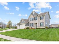 Two-story home featuring a three-car garage and a lush front lawn with manicured landscaping and a concrete driveway at 1334 Winfield Way, Greenwood, IN 46143