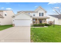 Charming two-story home featuring a two-car garage, stone accents, and a well-manicured lawn at 15144 Dry Creek Rd, Noblesville, IN 46060