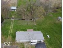Sprawling property featuring lush lawns, mature trees, and a charming home with a metal roof at 3335 W 400 N, Anderson, IN 46011