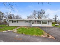 Charming single-story home with a well-maintained yard and enclosed front porch at 3335 W 400 N, Anderson, IN 46011