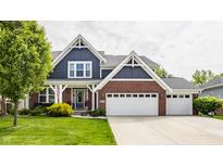 Charming two-story home featuring a brick and blue facade, complemented by a well-manicured lawn at 3640 Snowdon Dr, Westfield, IN 46074