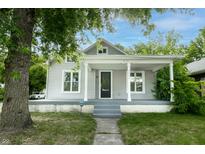Charming home featuring a welcoming front porch and beautifully maintained landscaping at 3902 N Capitol Ave, Indianapolis, IN 46208